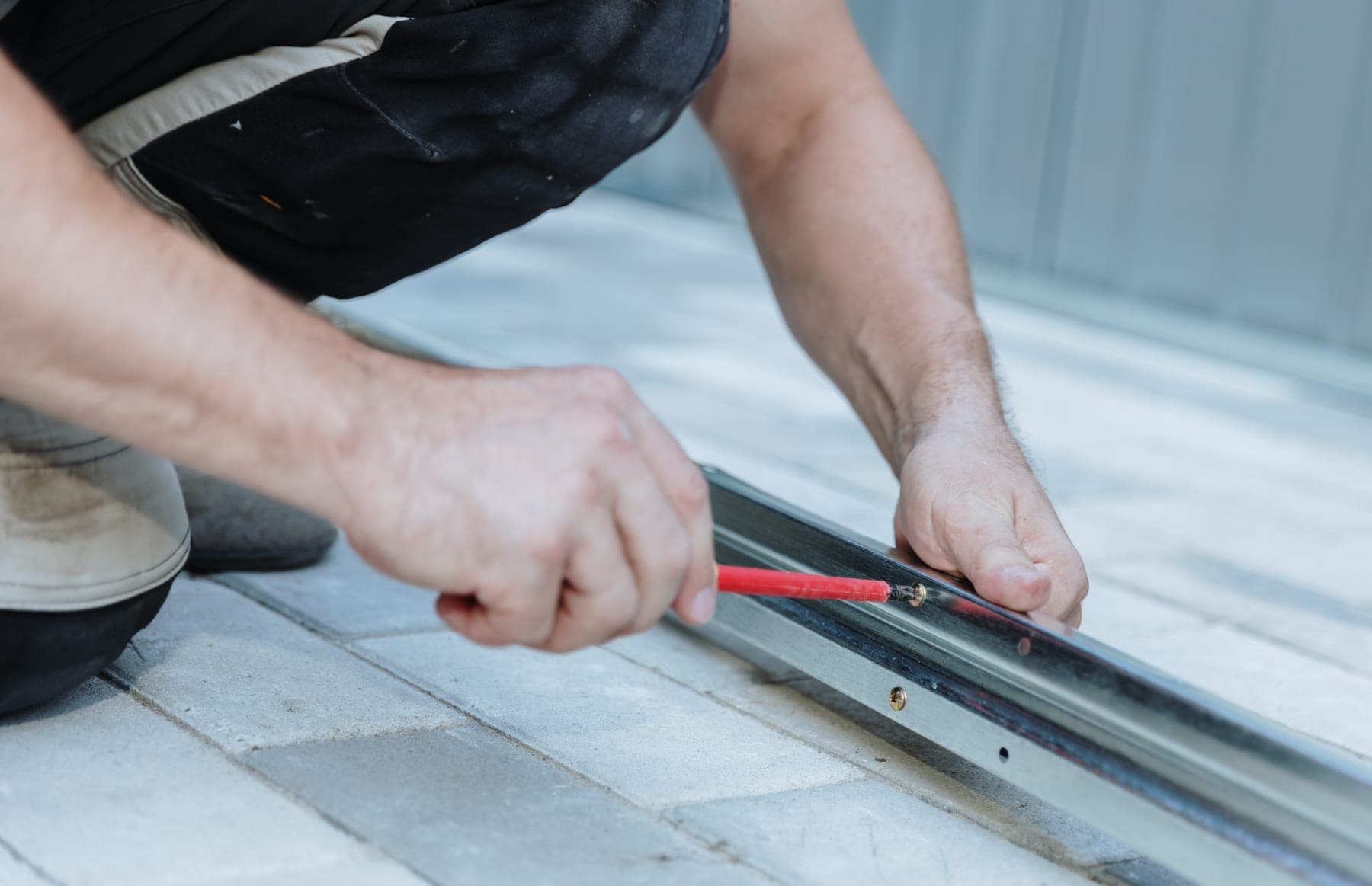 Roof plumber fixing a gutter bracket